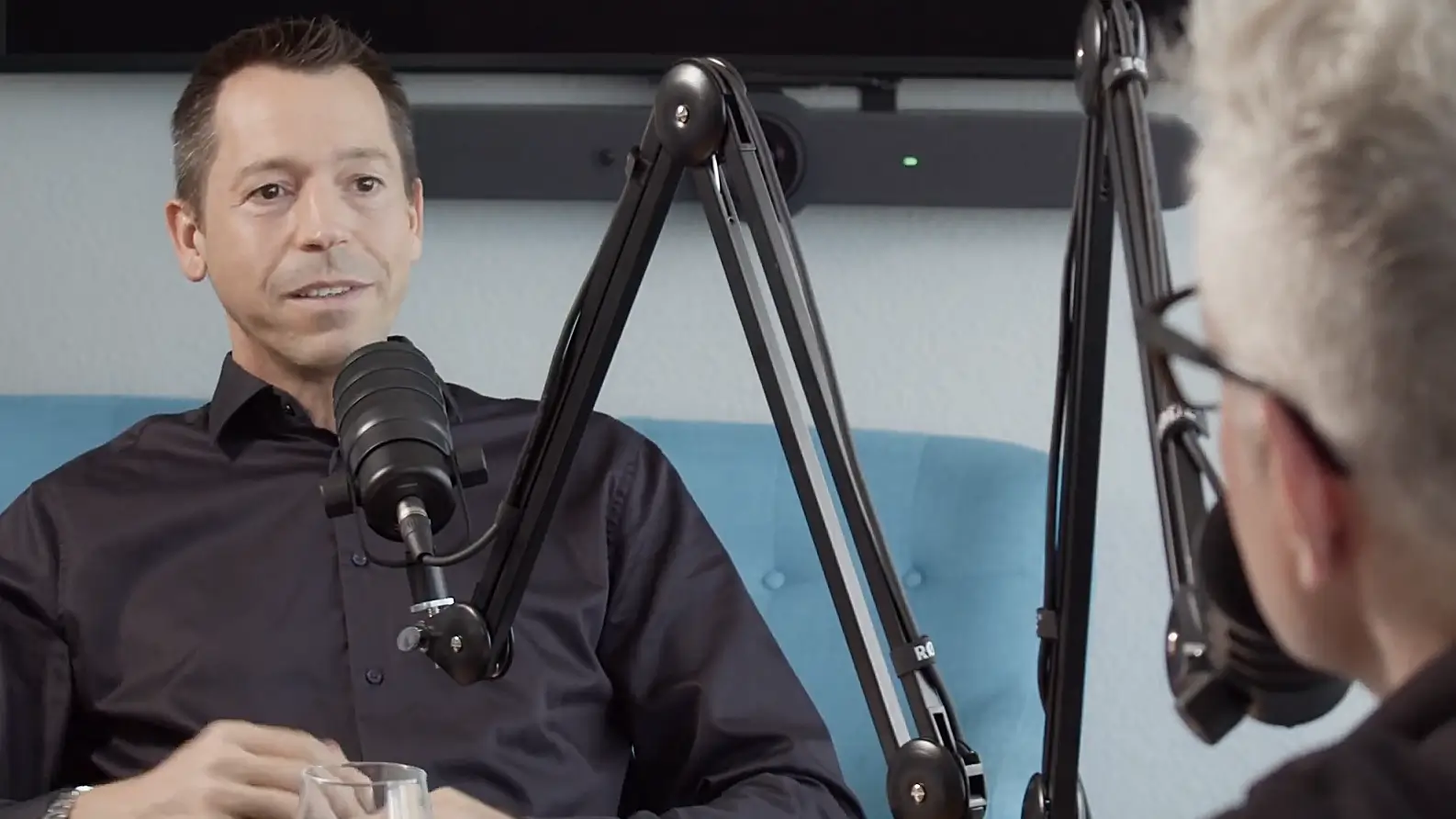Michael Rasimus speaking in a podcast studio