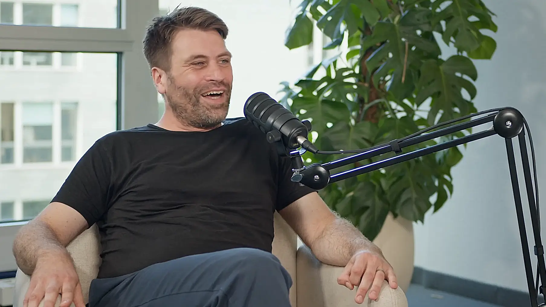 Mattias Benesch speaking in a podcast studio