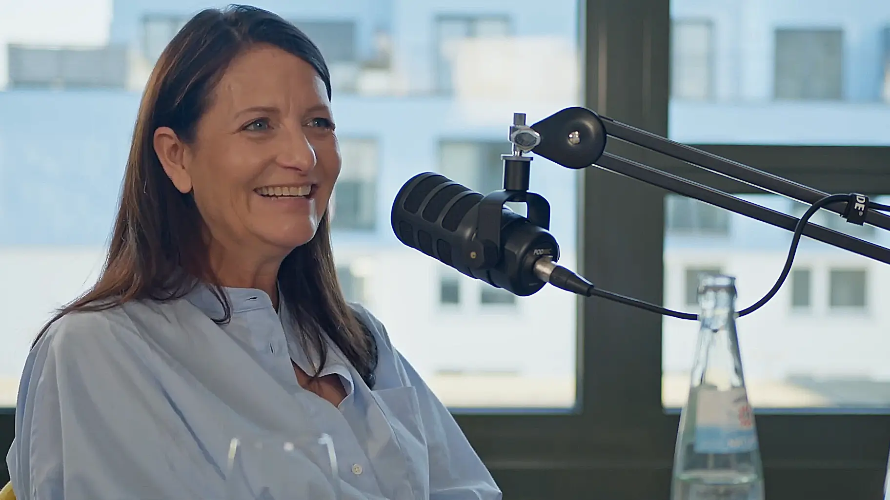 Beate Rank speaking in a podcast studio