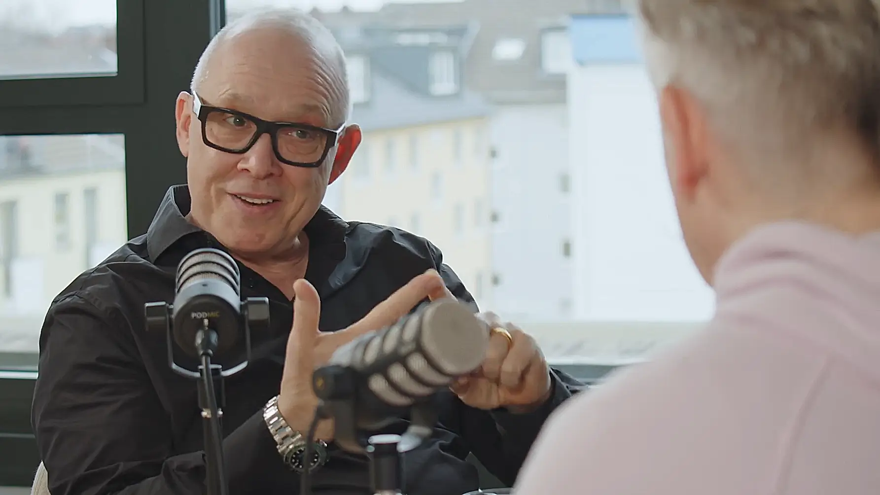 Daniel Attallah speaking in a podcast studio